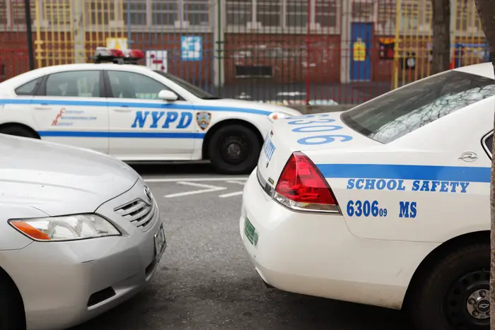 NYPD school safety division cars parked outside of a school.